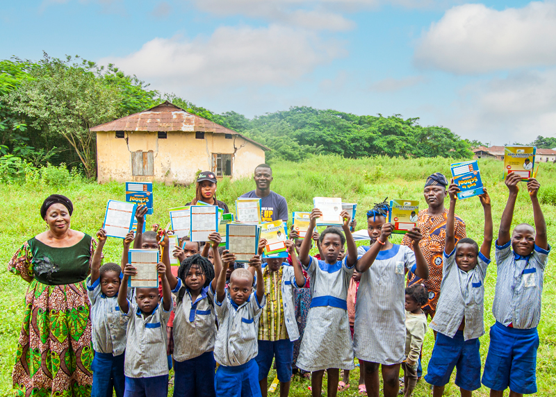 Children raising their back to school materials at Ayo Fatokun Foundation